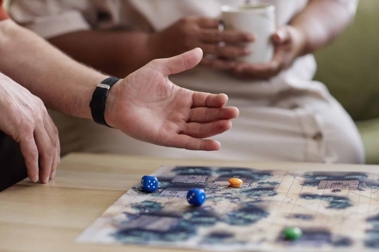 Family playing board game at Lola's House with dice and game pieces.