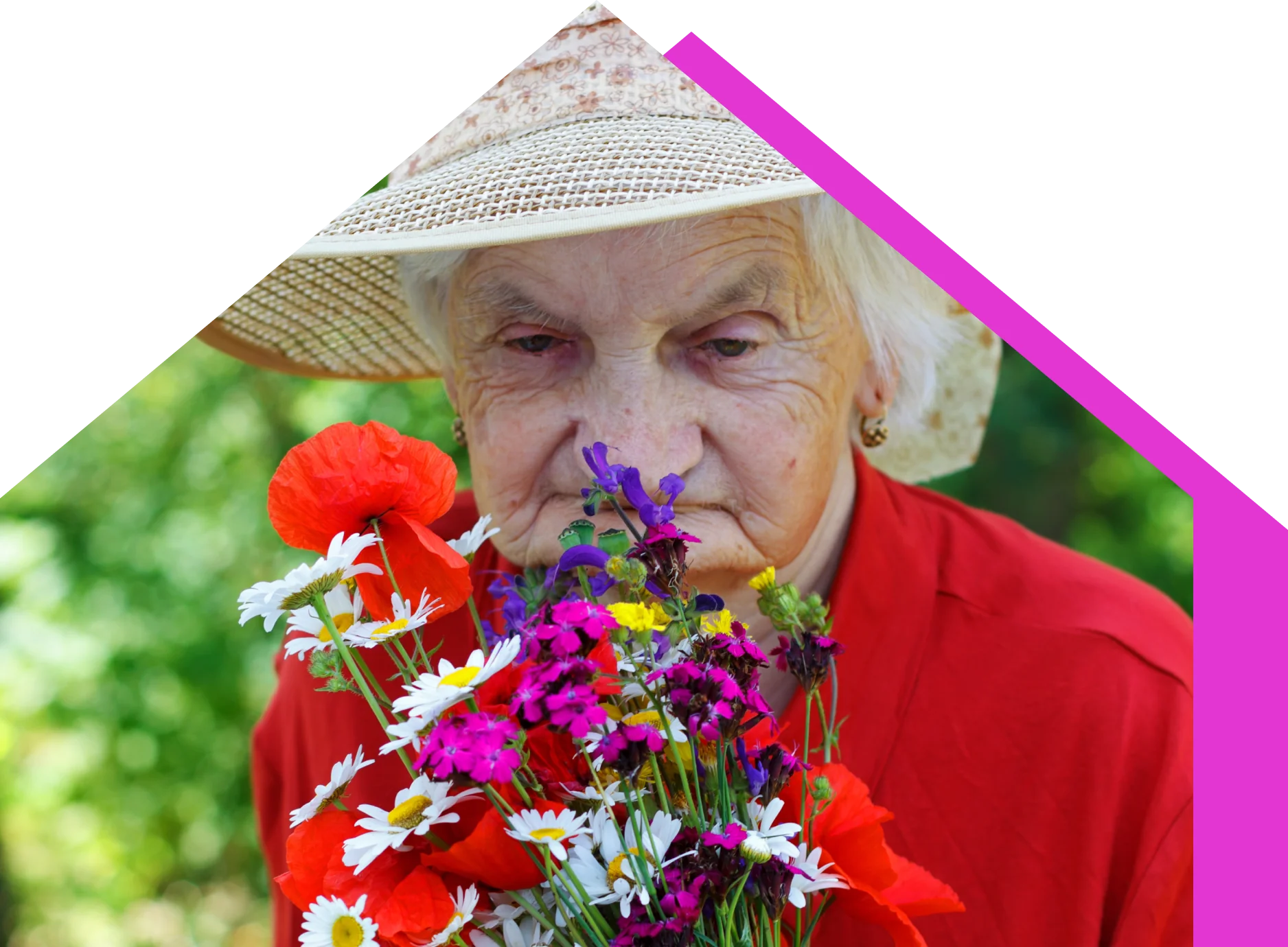 A resident in a sun hat holding a bunch of poppies and daisies in the garden