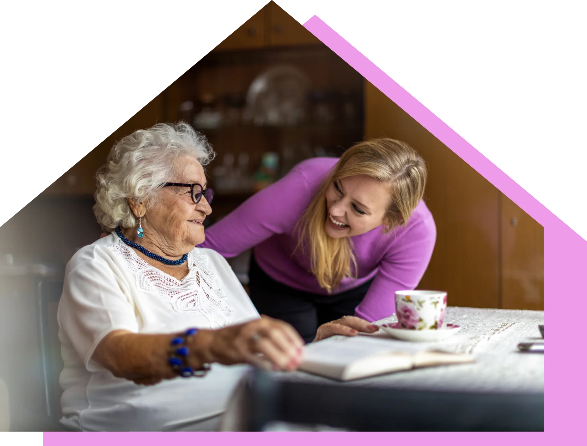 A carer chatting with a resident over a cup of tea at Lola’s House